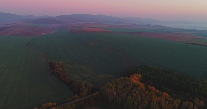 Aerial drone fly over northern Hungarian landscape at sunrise. Northern Matra mountains and hills.