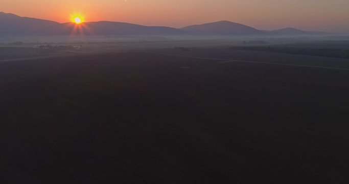 Aerial drone fly over northern Hungarian landscape at sunrise. Northern Matra mountains and hills.