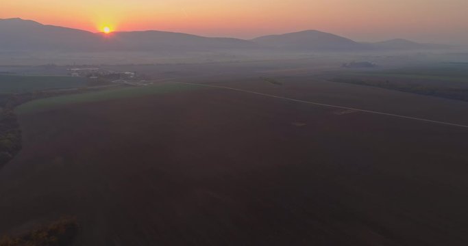 Aerial drone fly over northern Hungarian landscape at sunrise. Northern Matra mountains and hills.