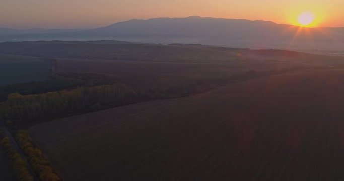 Aerial drone fly over northern Hungarian landscape at sunrise. Northern Matra mountains and hills.