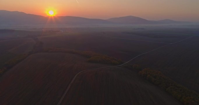Aerial drone fly over northern Hungarian landscape at sunrise. Northern Matra mountains and hills.