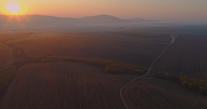 Aerial drone fly over northern Hungarian landscape at sunrise. Northern Matra mountains and hills.