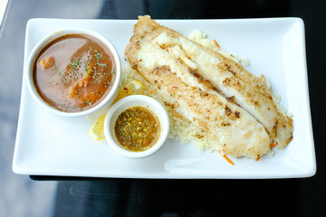 Grilled Pangasius with rice and garlic sauce, serve with mash potato.