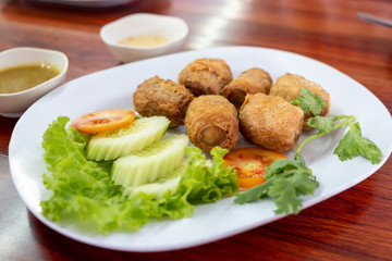 Deep Fried Crab meat roll or Hoi jo with sweet sauce on white plate , thai food, asian food, chinese food.