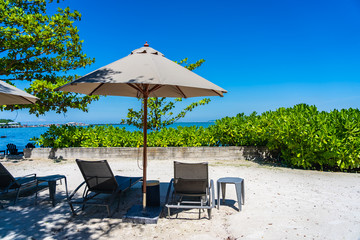Umbrella and chair on the beach and sea with blue sky