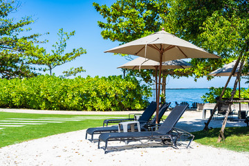 Umbrella and chair on the beach and sea with blue sky