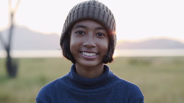 Medium close up of asian little girl smile and happy  enjoying Nature at sunset