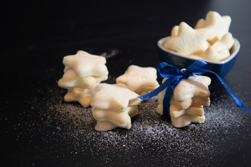 Cookies on black background. Preparing gifts for Christmas concept. Selective focus.