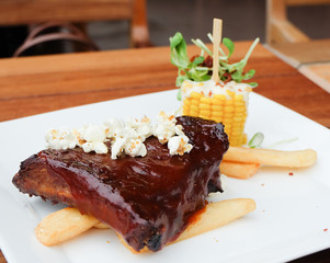 Barbecue ribs with fries and corn