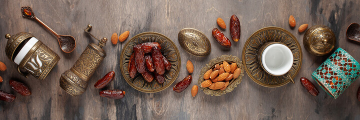 Dried dates and coffee on a dark background.Arabic traditional dishes, pots and dates fruits. Ramadan Kareem, Eid mubarak concept. Top view. Flat lay. Copy space
