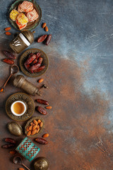 Dried dates and coffee on a dark background.Arabic traditional dishes, pots and dates fruits. Ramadan Kareem, Eid mubarak concept. Top view. Flat lay. Copy space