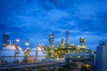 Gas storage sphere tanks and pipeline in oil and gas refinery industrial plant on blue sky twilight background