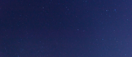 Panorama blue night sky milky way and star on dark background.Universe filled with stars, nebula and galaxy with noise and grain.Photo by long exposure and select white balance
