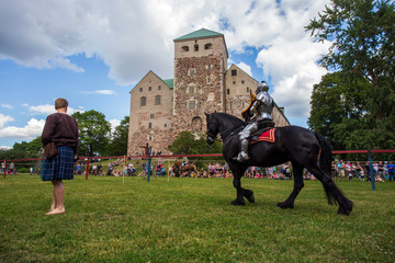 Knights mounted on horseback prepare to joust during a tournament in Turku, Finland.