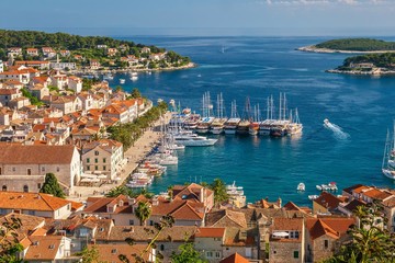 Naklejka na ściany i meble The old town and yacht harbor of the beautiful and popular tourist resort island of Hvar, a Dalmatian island in the Adriatic Sea in Croatia. 