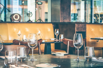 Interior of modern vintage restaurant in vintage tone, Empty glasses set on the table.