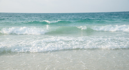 Very beautiful seascape panorama. Composition of nature.Sea wave with bubbles hits the sand beach wallpaper with sunlight.beach in sunset time.