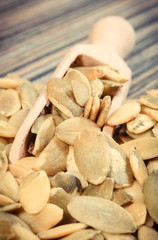 Heap of pumpkin with spoon on board. Healthy food containing dietary fiber