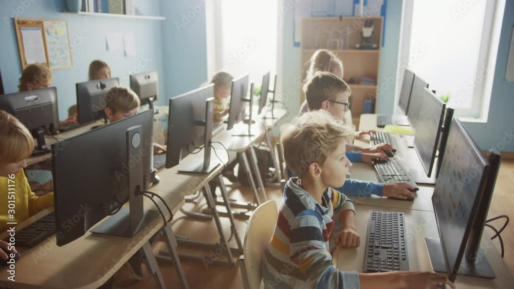 Wall mural elementary school computer science classroom: diverse group of little smart schoolchildren using per