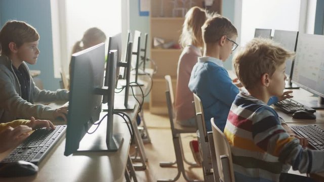 Elementary School Computer Science Classroom: Diverse Group of Little Smart Schoolchildren using Personal Computers, Learn Informatics, Internet Safety, Programming Language for Software Coding