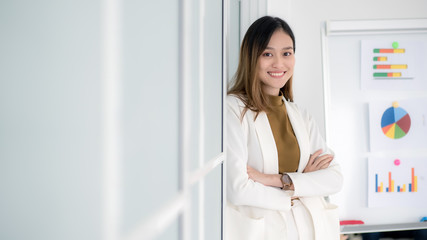 Fototapeta na wymiar Attractive young Asian smiling woman in smart casual in office