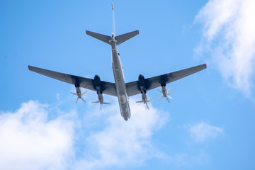 Military aircraft in the sky against the clouds above us.