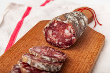 pork dry sausage on wooden board