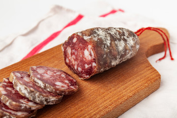 pork dry sausage on wooden board