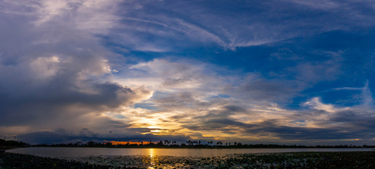Panorama Sunlight with dramatic sky. sunset on dark background.Vivid orange cloud sky.