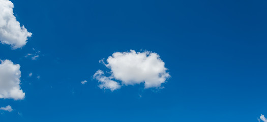 Fototapeta na wymiar White clouds cumulus floating on blue sky for backgrounds concept, For putting text or advertising products.panorama.