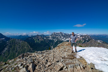Fototapeta premium Adventurous man hiking on top of a mountain.