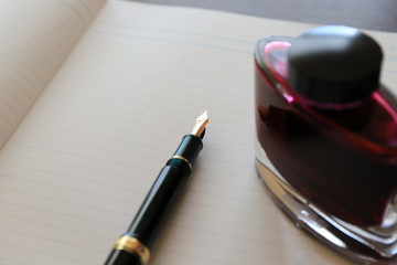 note and fountain pen on table