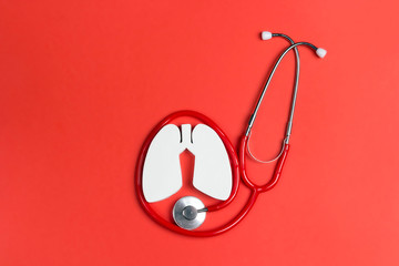 Lung symbol and stethoscope on a red background. Prevention of pulmonary disease.
