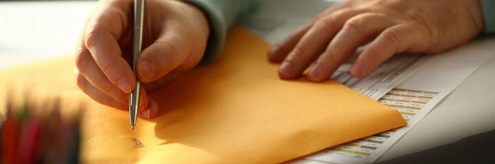 Male hand holding silver pen