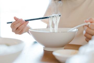 Asian woman washing hands  in a sink