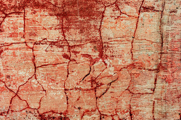 Texture of a concrete wall with cracks and scratches which can be used as a background
