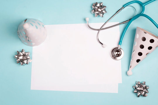 Doctor's or nurse day greeting card with stethoscope and festive caps on blue background.