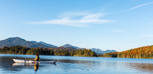 side view of a white kayak on Boreas Ponds in the Adirondack mountains