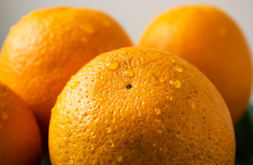 Orange fruit with orange slices and leaves on white  background.