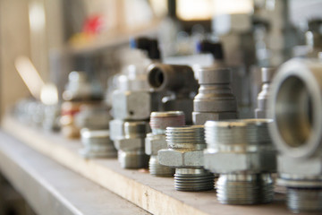 Metal bolts and nuts in a row background. Chromed screw bolts and nuts isolated. Steel bolts and nuts pattern. Set of Nuts and bolts. Tools for work