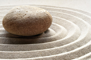Fototapeta na wymiar zen garden meditation stone background with stones and lines in sand for relaxation balance and harmony spirituality or spa wellness