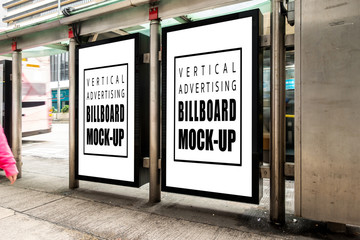 Mock up two blank vertical billboard on street in city