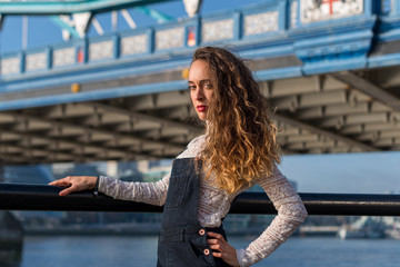 Spanish woman with curly and blond hair on the London bridge