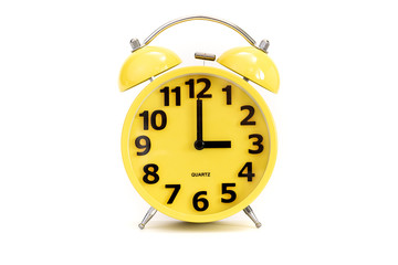 Yellow alarm clock on white at 3 o'clock