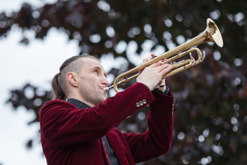 attractive male trumpeter blowing his musical instrument