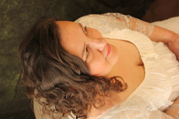 Naklejka premium Portrait of a full happy woman in a white dress. plus size model