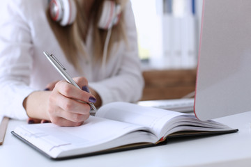 Female hands making notes with silver pen