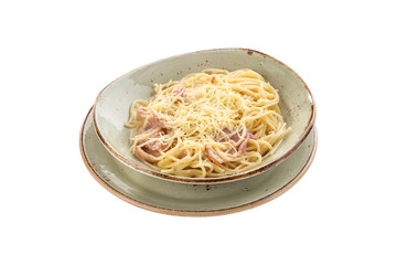 Spaghetti Carbonara with bacon and cheese on grey plate isolated on white background