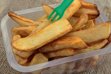 tray of french fries on a wooden table