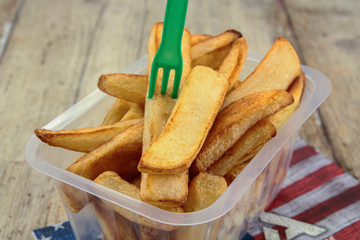 tray of french fries on a wooden table